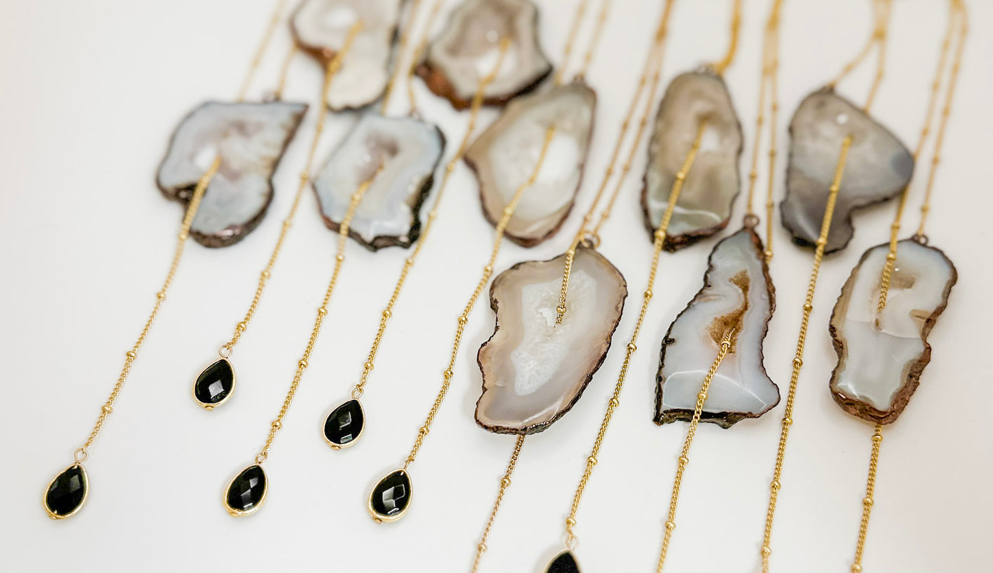 Necklaces with agate slices on a white background